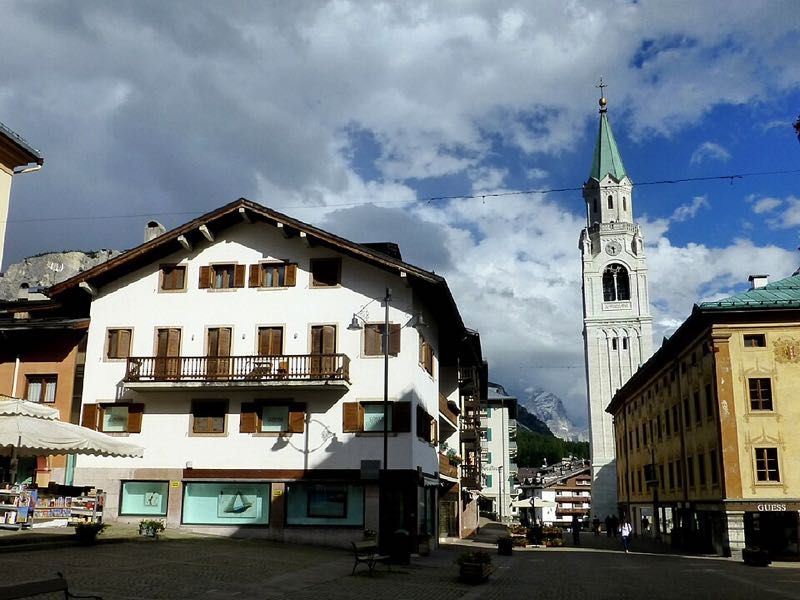 Cortina d’Ampezzo bell tower framed by Dolomite peaks